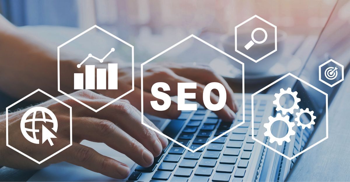 Person typing on a laptop with overlay of hexagons featuring SEO-related icons, representing the integration of technology and agentic AI in enterprise SEO strategies.