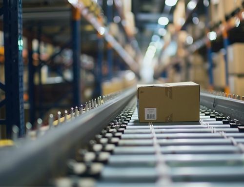 A cardboard box moving down a conveyor belt inside a warehouse, representing the automation and efficiency enabled by Gysho’s Self-Learning Autonomous Supply Chain AI solution.